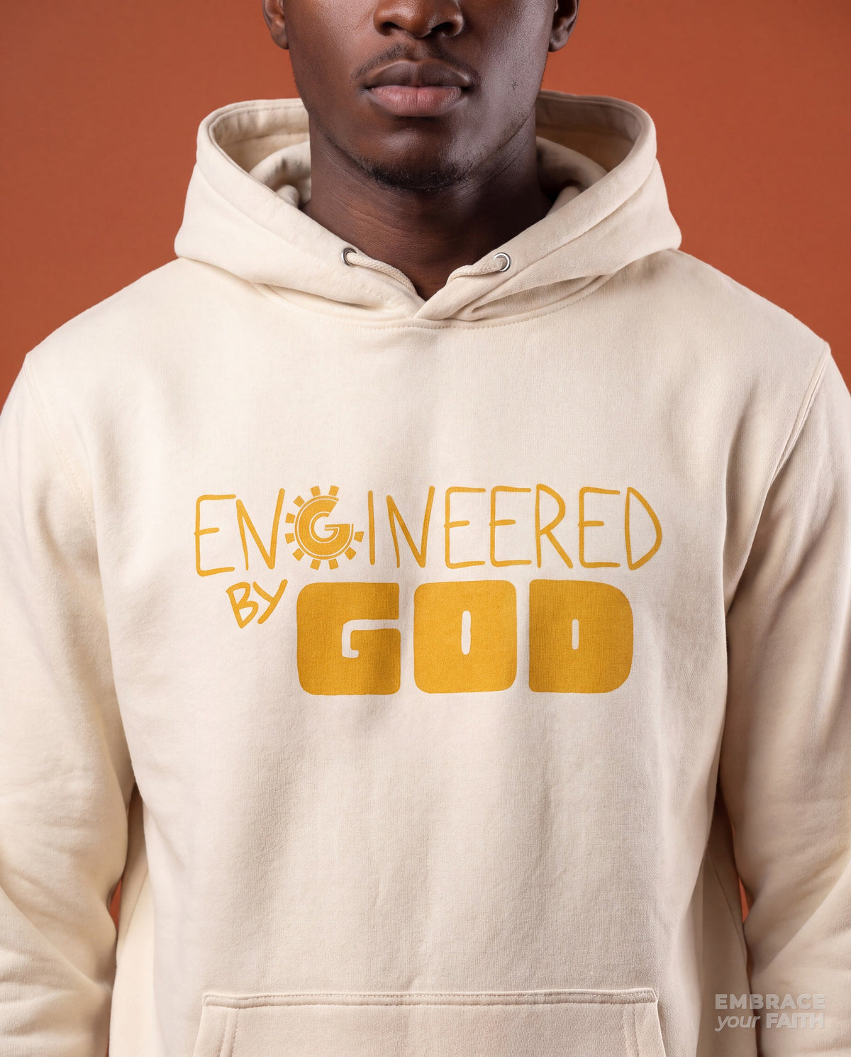Close-up of the print on the Engineered By God (Golden Hologram) Classic Unisex Hoodie in Bone