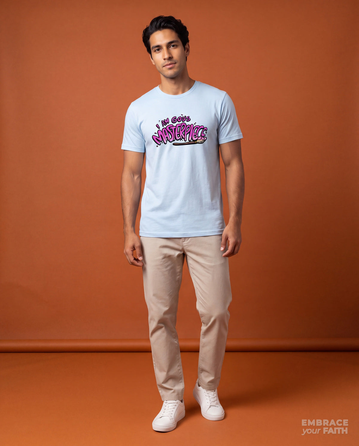 EYF model wearing the I Am God's Masterpiece Unisex Classic T-Shirt – Pink Print in Light Blue