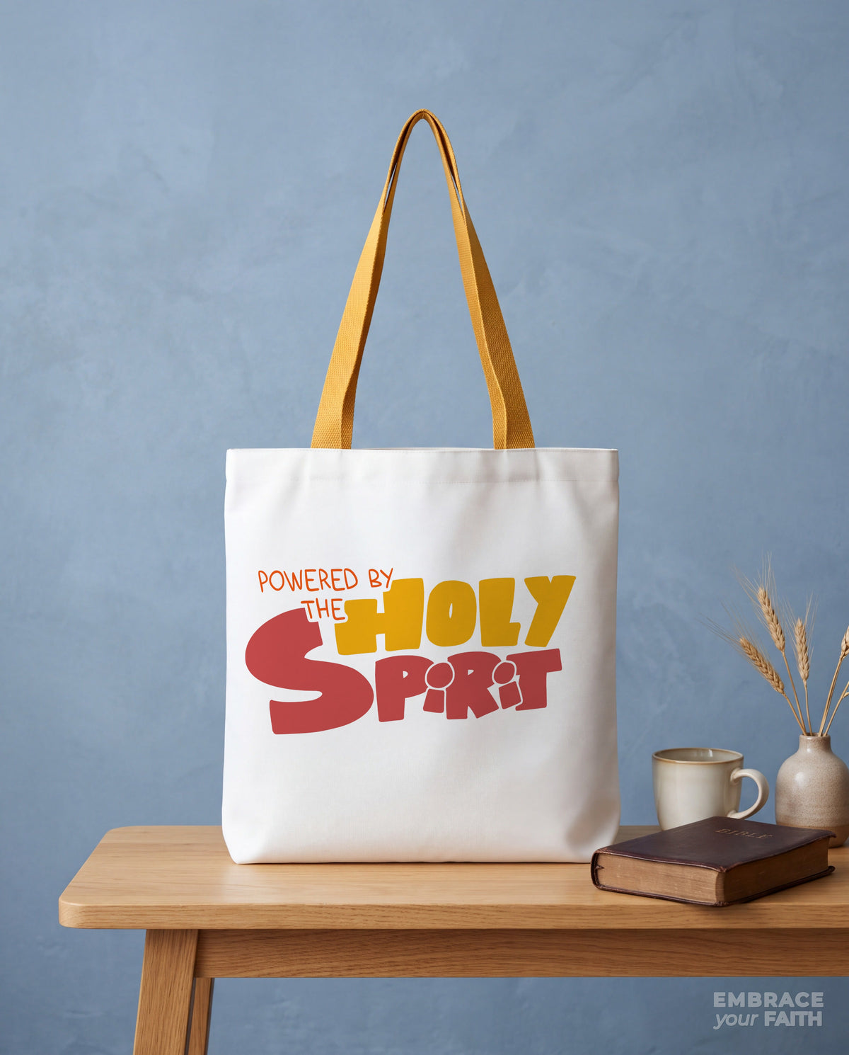 Styled still life of the Powered by the Holy Spirit Tote Bag